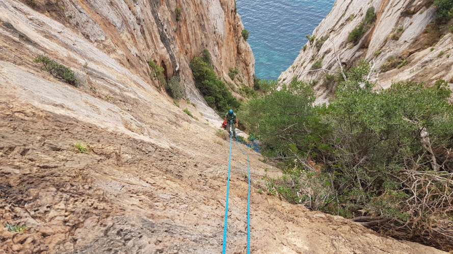 Person descending into the Porto Flavia canal with a rope