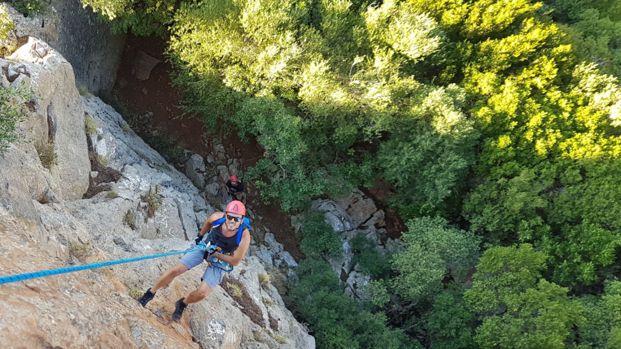 Person walking the via Ferrata di Gutturu Xeu in Iglesias in south-west Sardinia