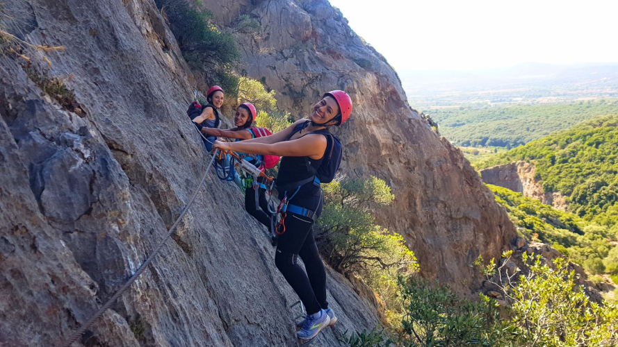 Two girls smile as they walk the Via Ferrata di Gutturu Xeu in Iglesias