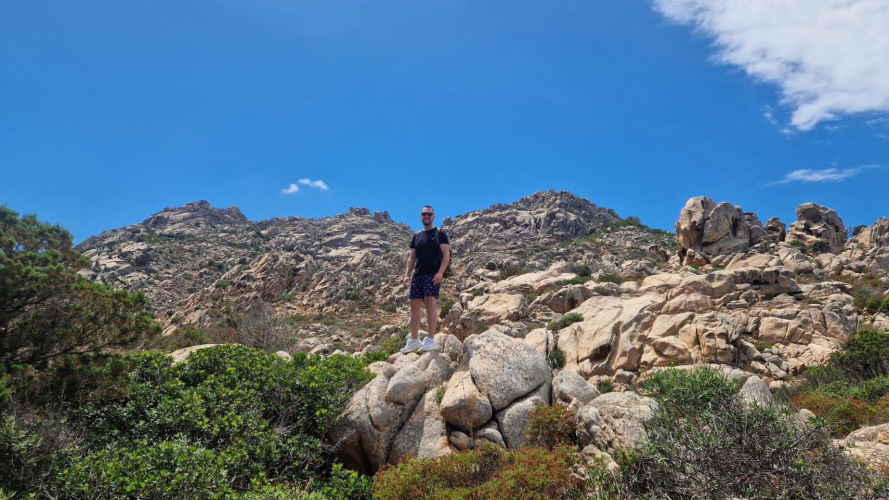 Hiker among the rocks of Cala Coticcio