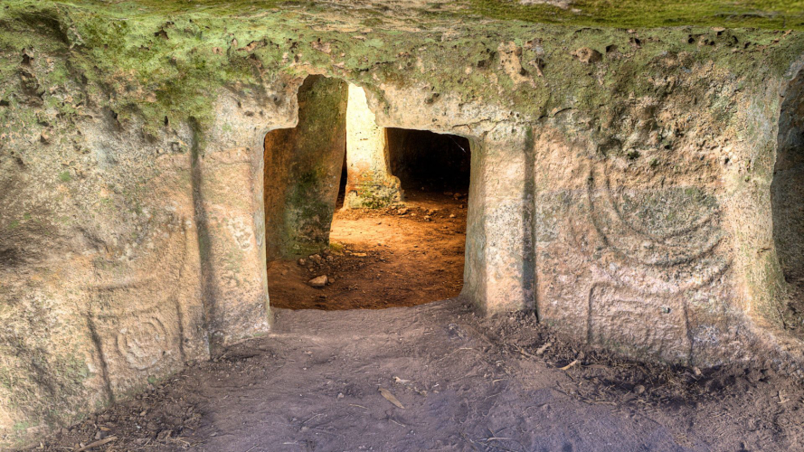 Entrance to a domus de janas in the Alghero area with ancient symbols
