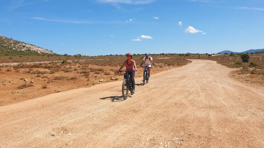 Dos excursionistas pedalean durante una excursión en bicicleta eléctrica en el Supramonte