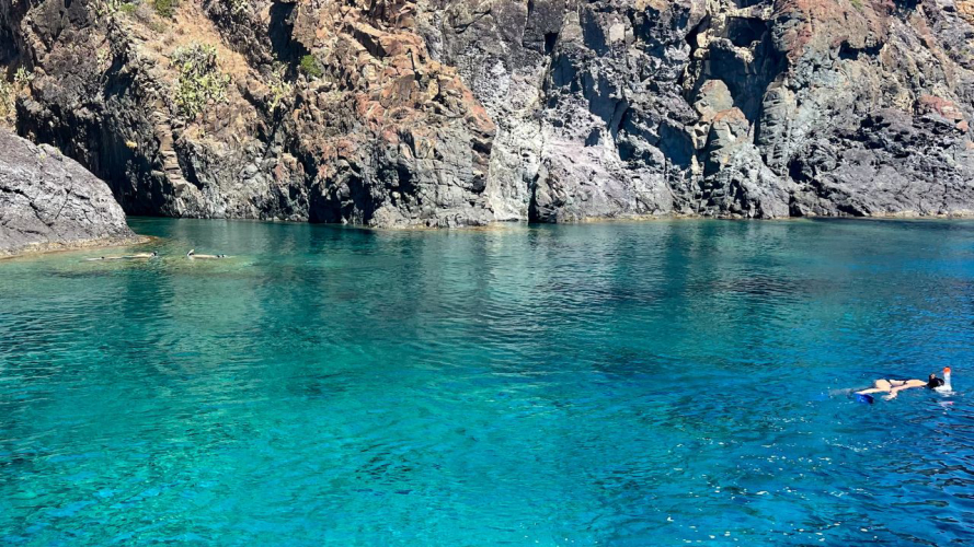 aguas cristalinas verde esmeralda de Bosa y una mujer nadando