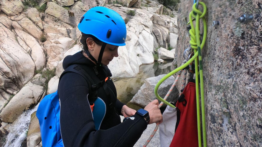 Girl sets up rope for rappelling in Bau Mela