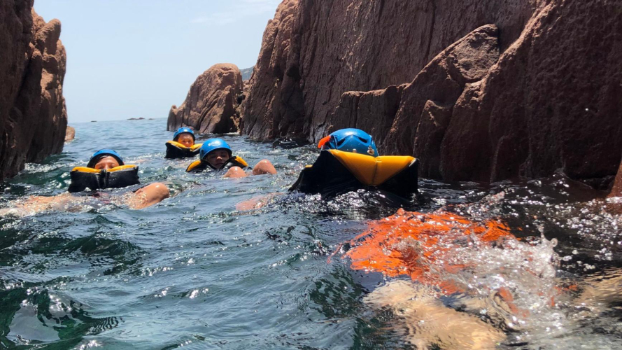 Boys swim while canyoning in Bau Mela