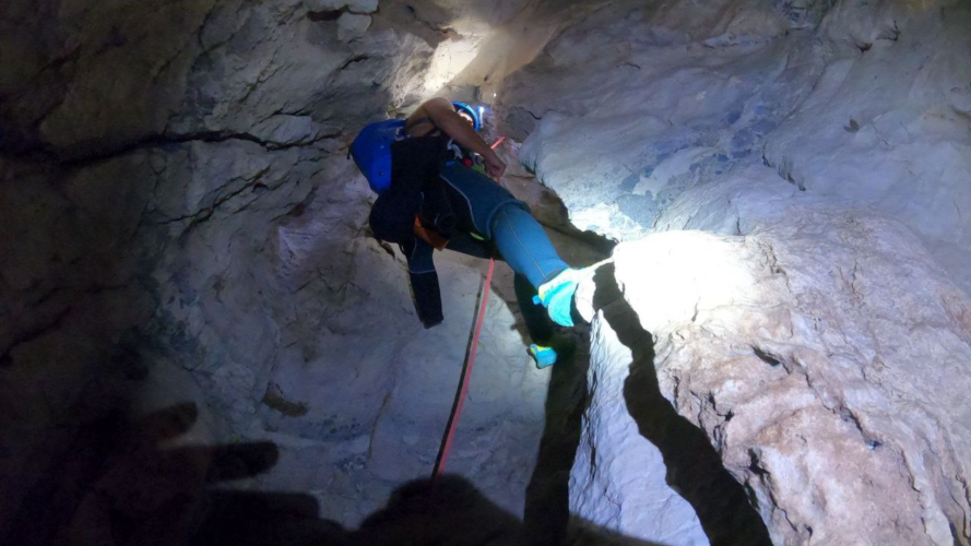 Escursionista si cala con la corda all'interno della Grotta Donini