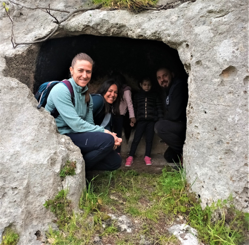 Domus de janas and tourists during donkey trekking in Cargeghe