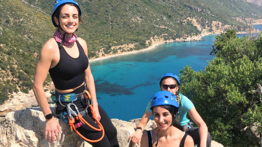 Gruppo di escursionisti durante calata in corda con guida e attrezzatura