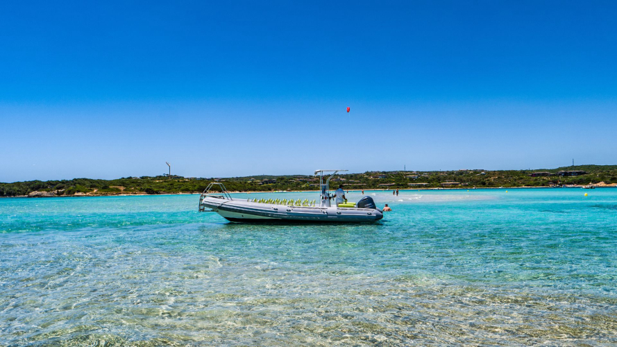 Maxi inflatable boat stops in the blue waters of Piana Island