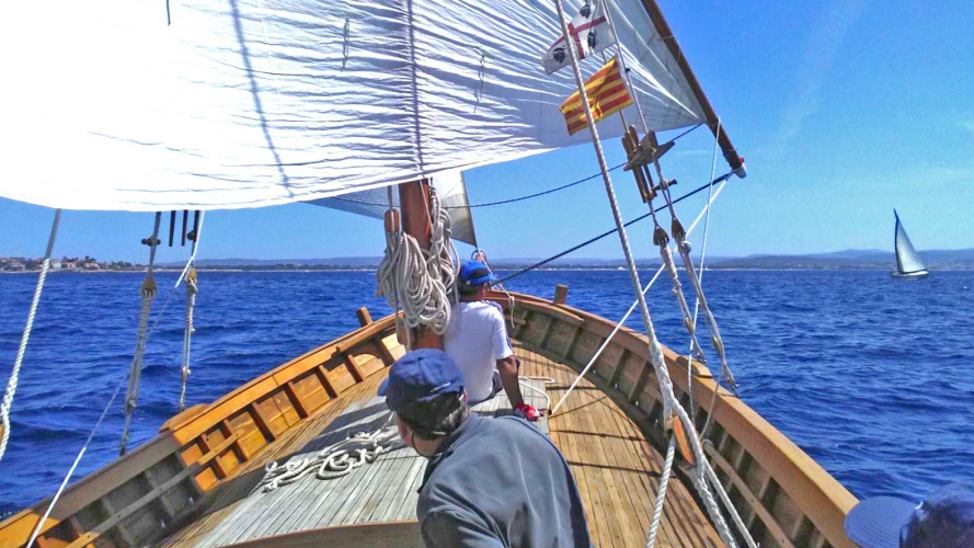 Lateen sailboat sailing in the sea of Alghero