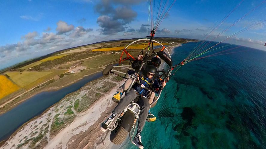 Powered paragliders fly over Oristano coastline
