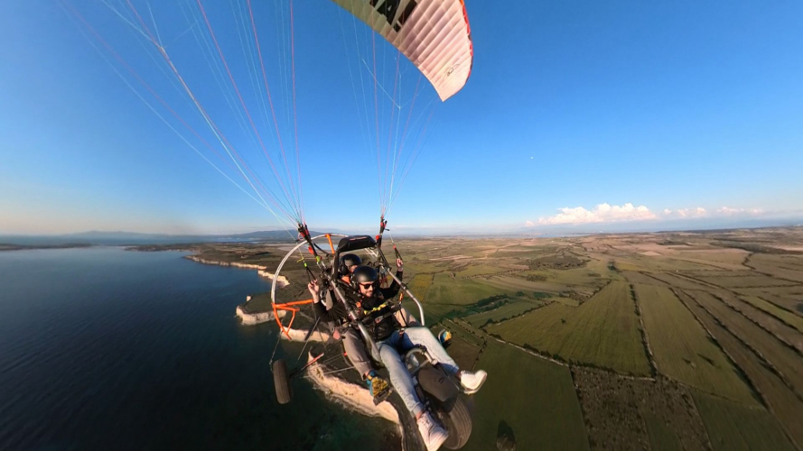 Tandem paragliding flight over the Cabras coastline