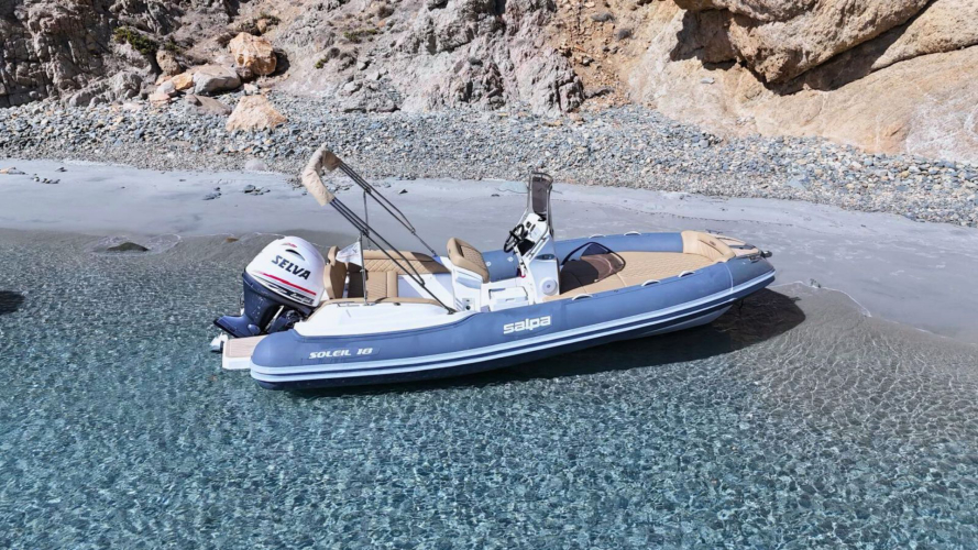 Dinghy in the crystal-clear waters of Villasimius