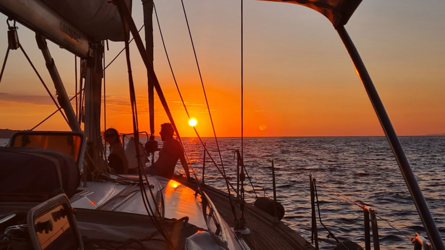 Segelboot bei Sonnenuntergang während der Tour im Golf von Cagliari