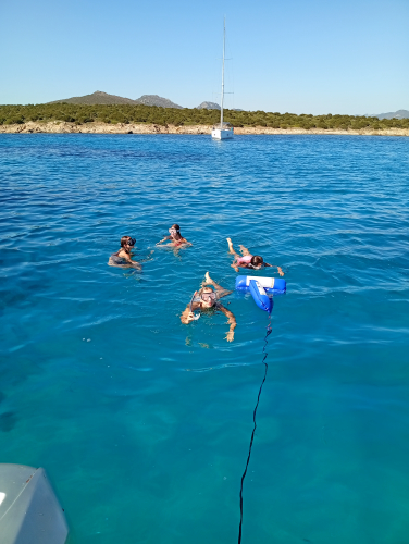 Tourists swim in the emerald waters of the sea between Cugnana and Cala di Volpe