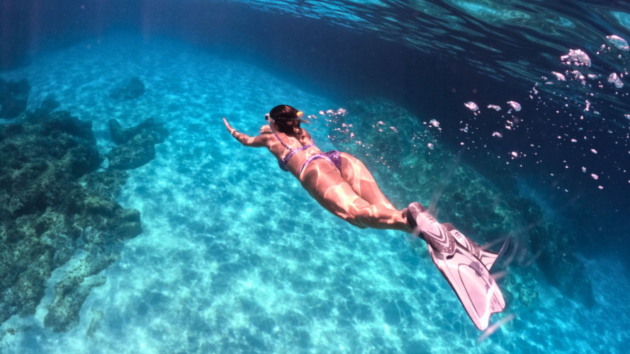 Girl snorkelling in the waters of the Gulf of Orosei
