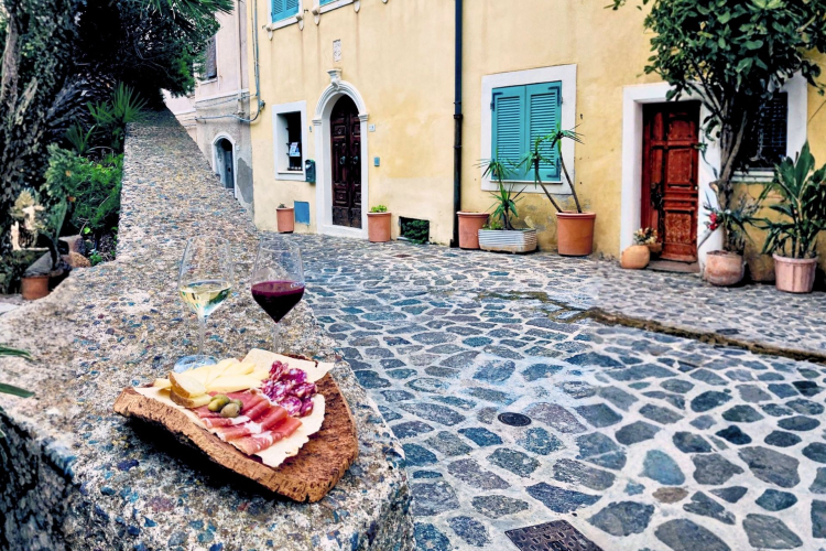 Calicini di vino e degustazione di prodotti tipici nelle strade di Castelsardo