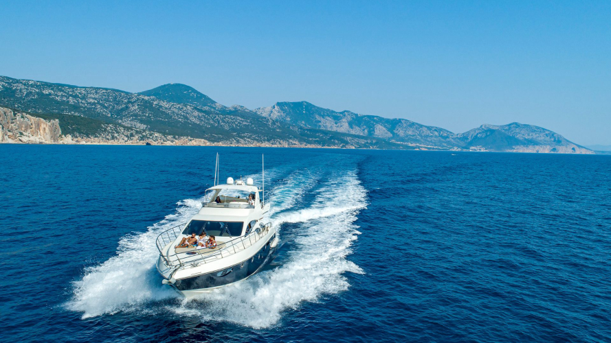 Lussuoso yacht di lusso che naviga con passeggeri a bordo in un mare blu in Costa Smeralda