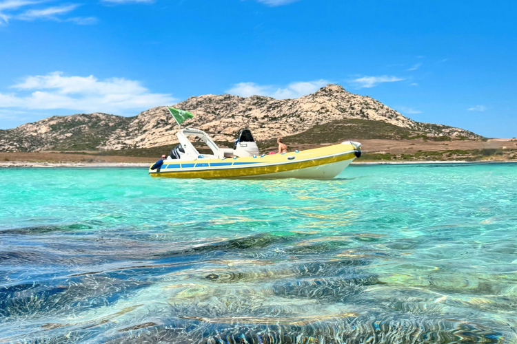 Dinghy while sailing in the crystal clear waters of Stintino