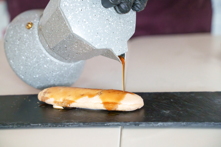 The ladyfinger is drenched in coffee