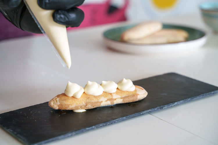 The ladyfinger is covered with cream using a special chef's technique