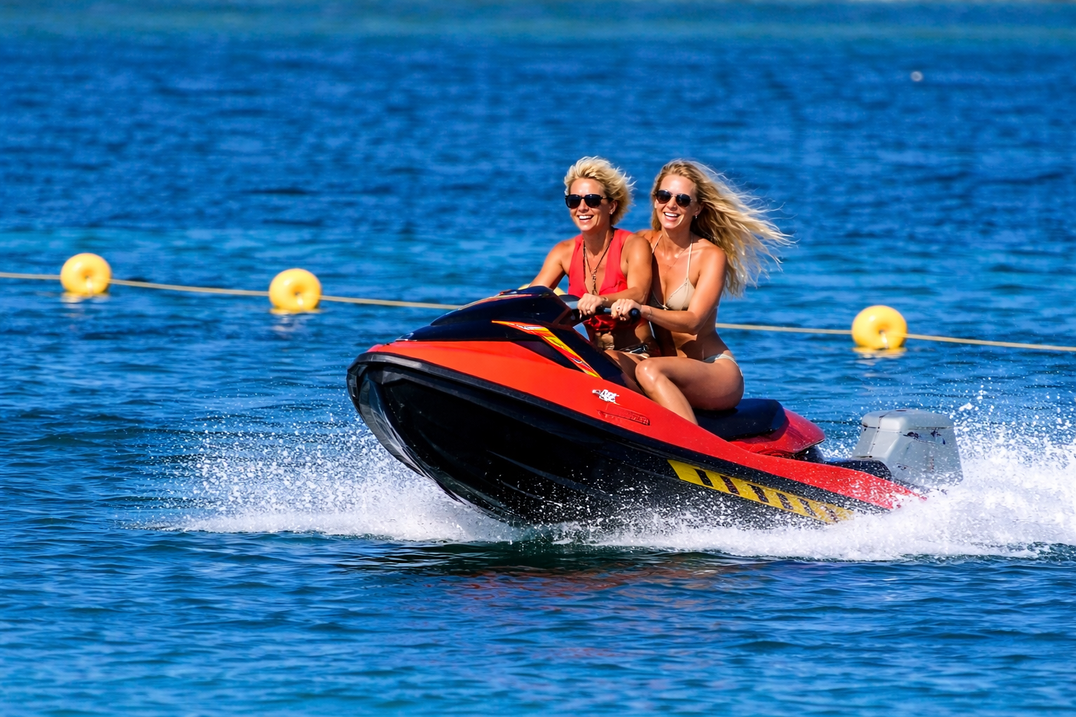 Due donne si godono di un'esperienza di noleggio moto d'acqua ad Alghero