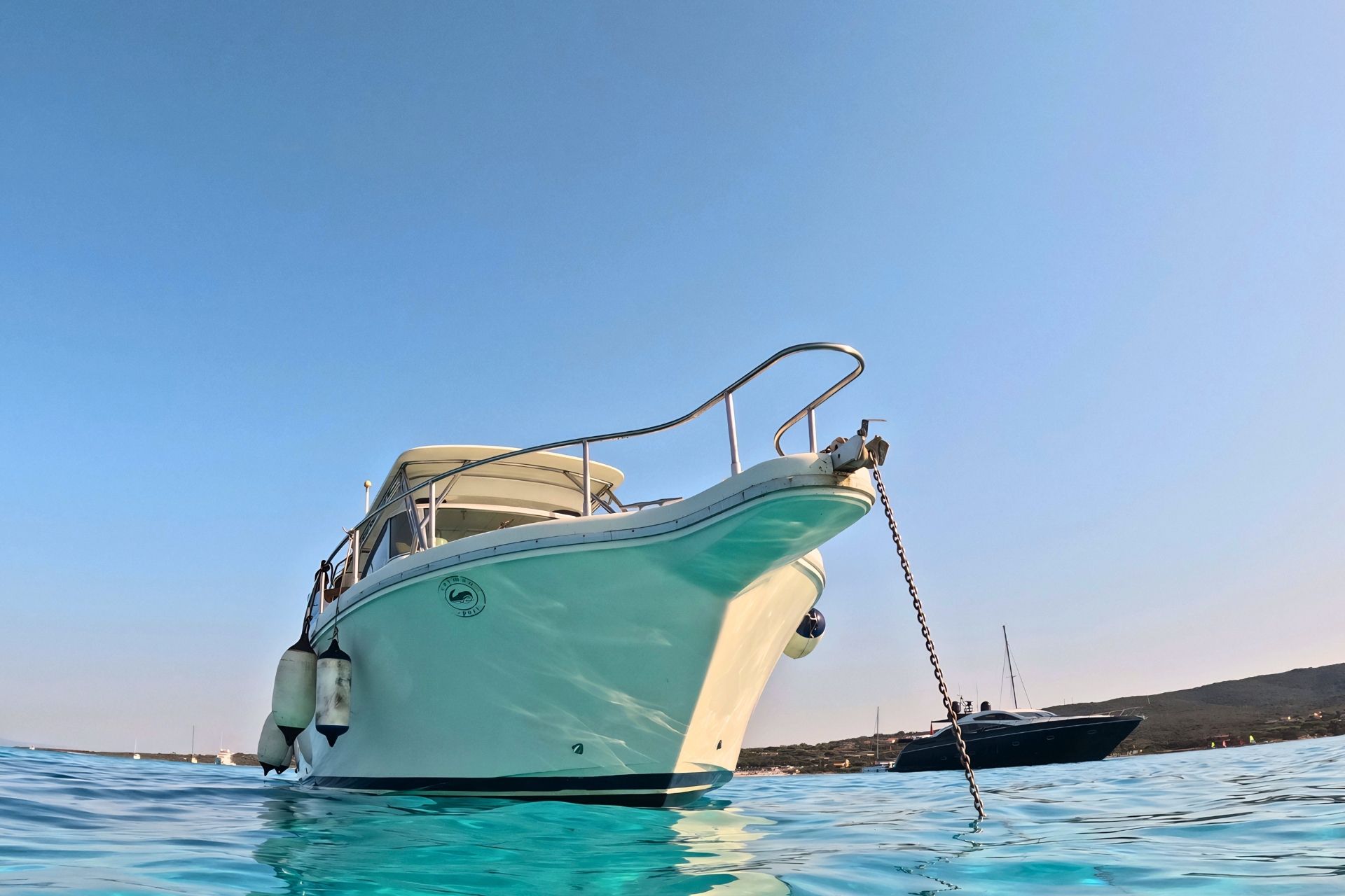 Motor boat in the turquoise waters of the Asinara Park