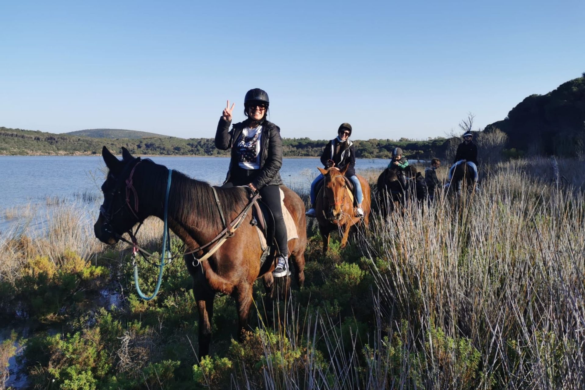 Persone a cavallo entrano al Lago di Baratz