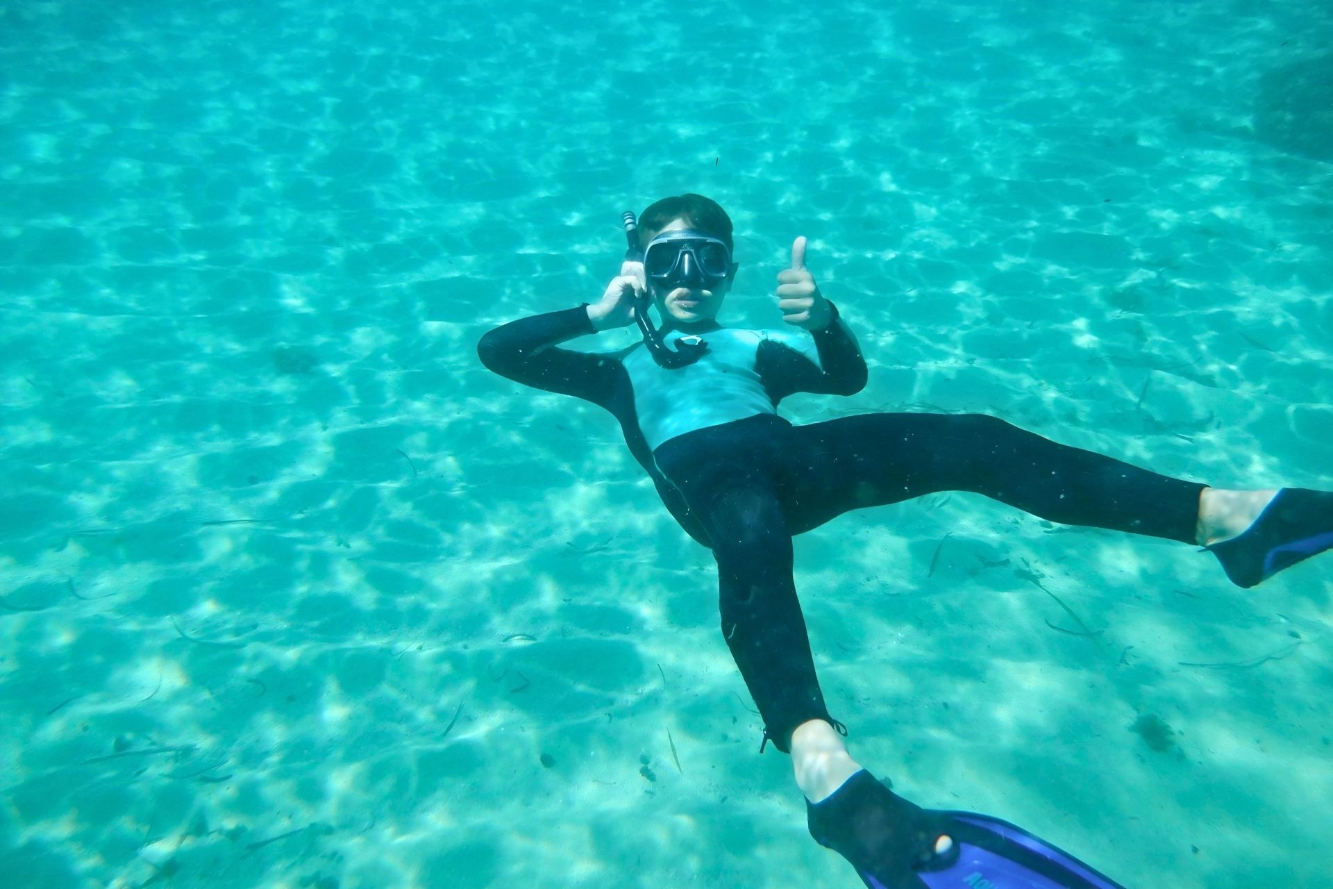 Child is snorkeling in Balai