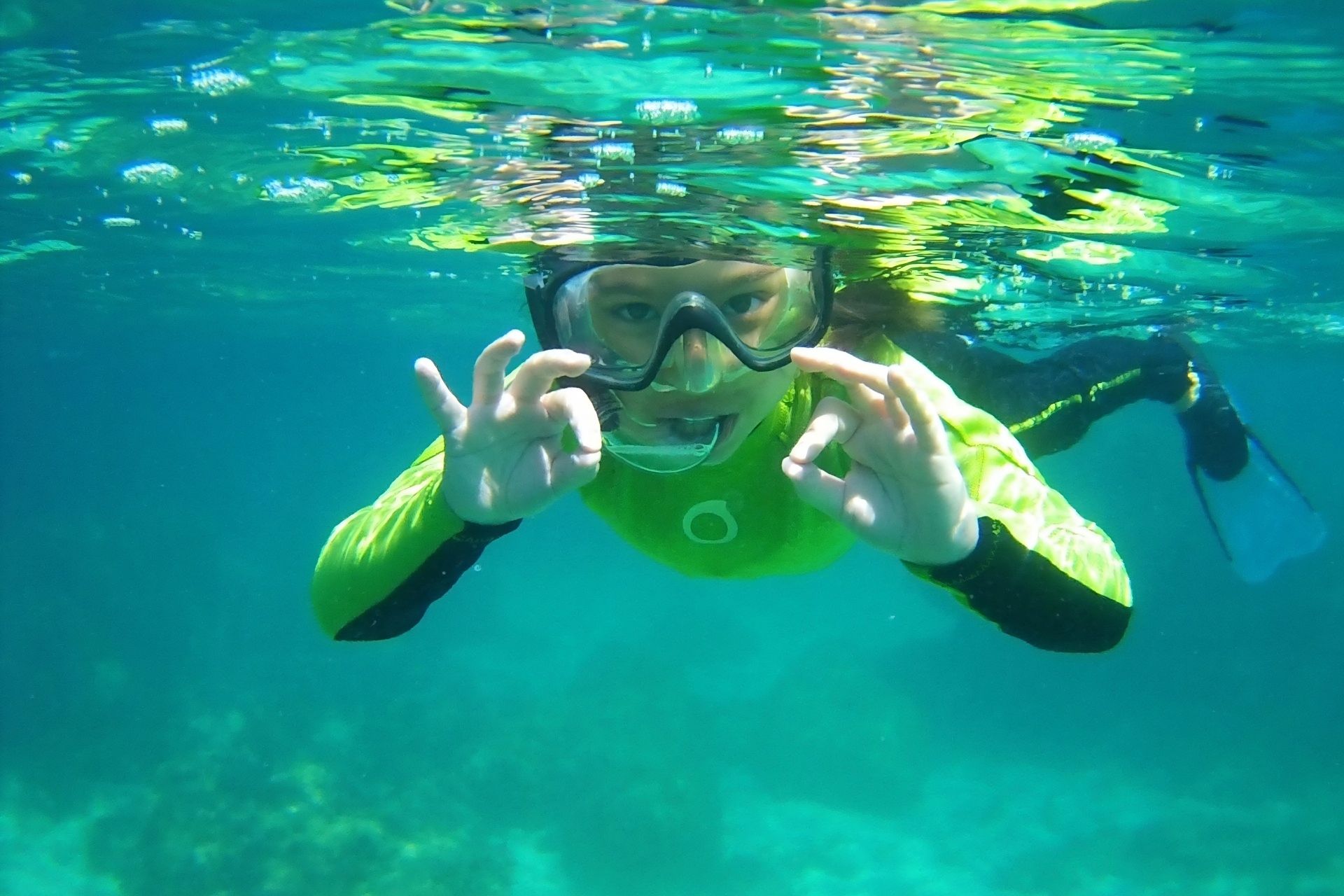 Child is snorkeling in Balai