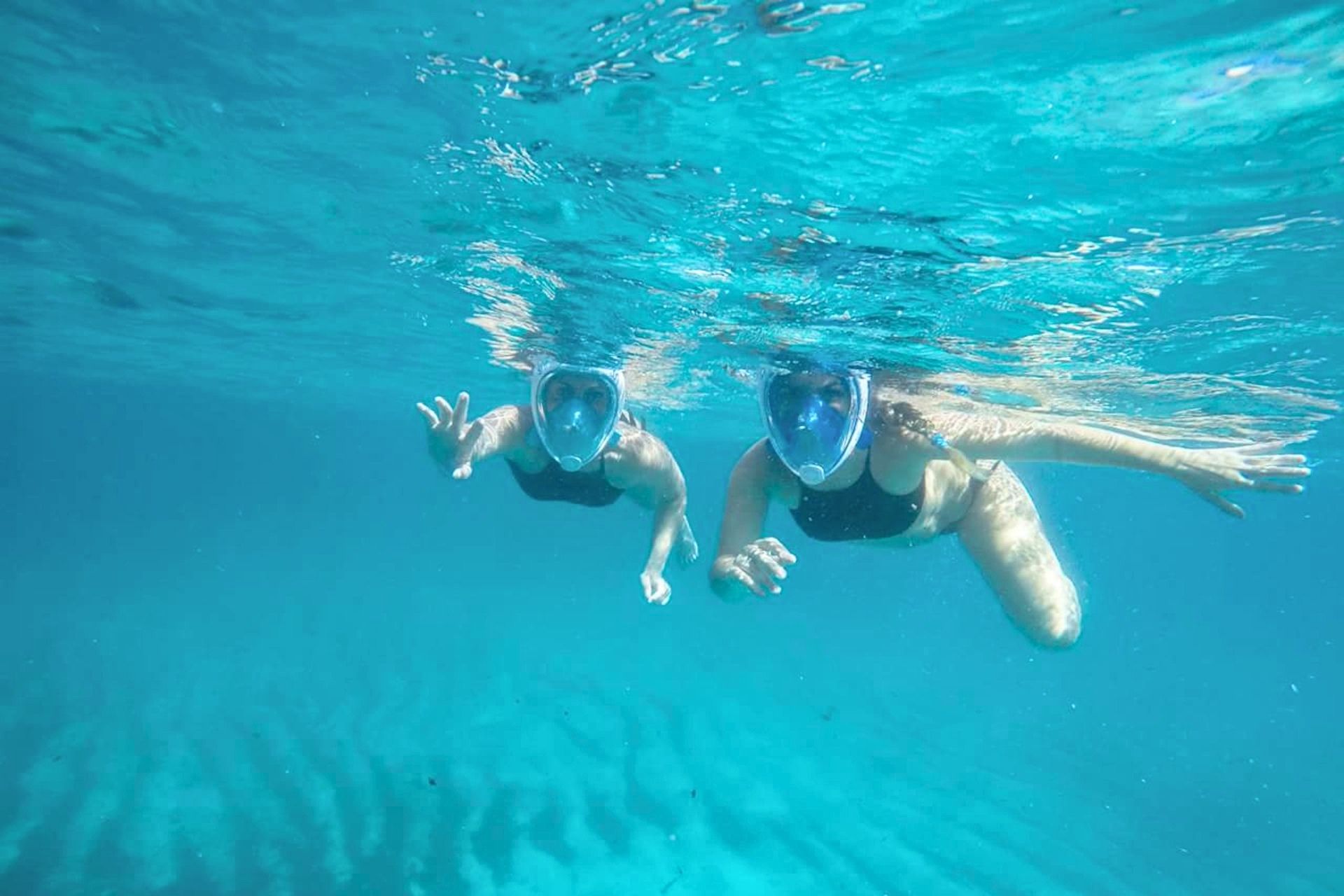 People snorkel in Balai
