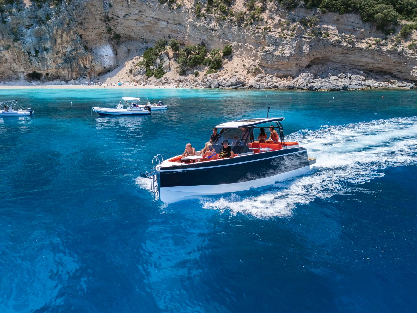 Mini yacht that sails in crystal clear waters with stops at sheltered beaches and sea caves to explore with snorkeling.