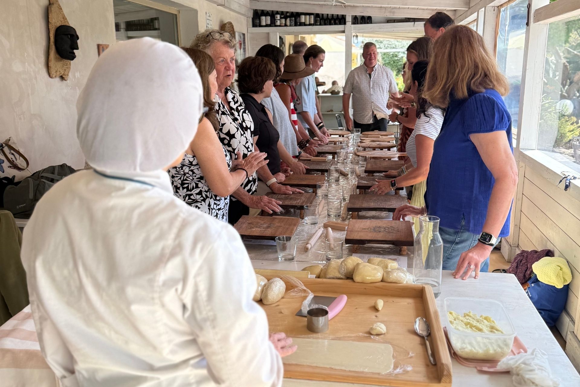People prepare fresh pasta by hand during a pasta workshop in Olbia.