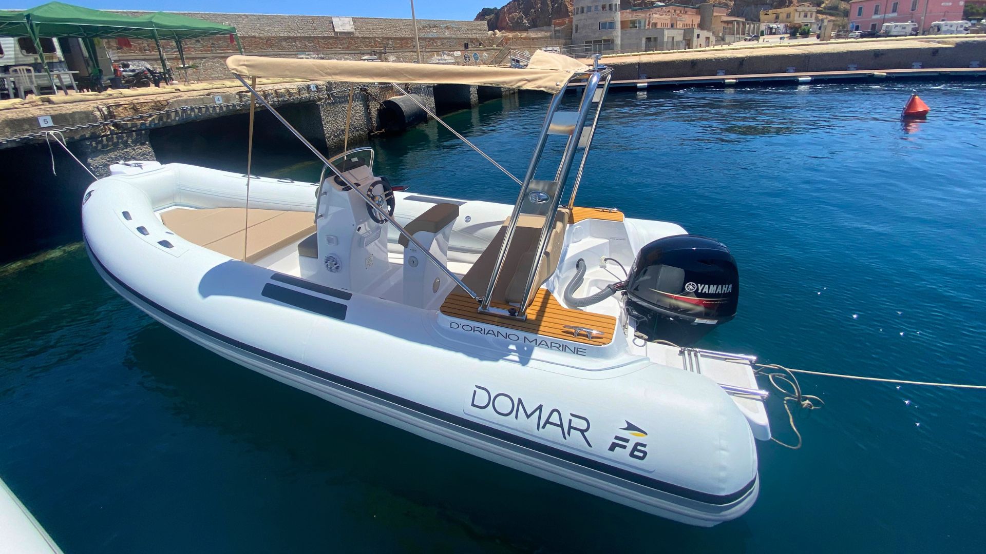 Picture of a Domar F6 dinghy moored in a port, ready for an adventure at sea
