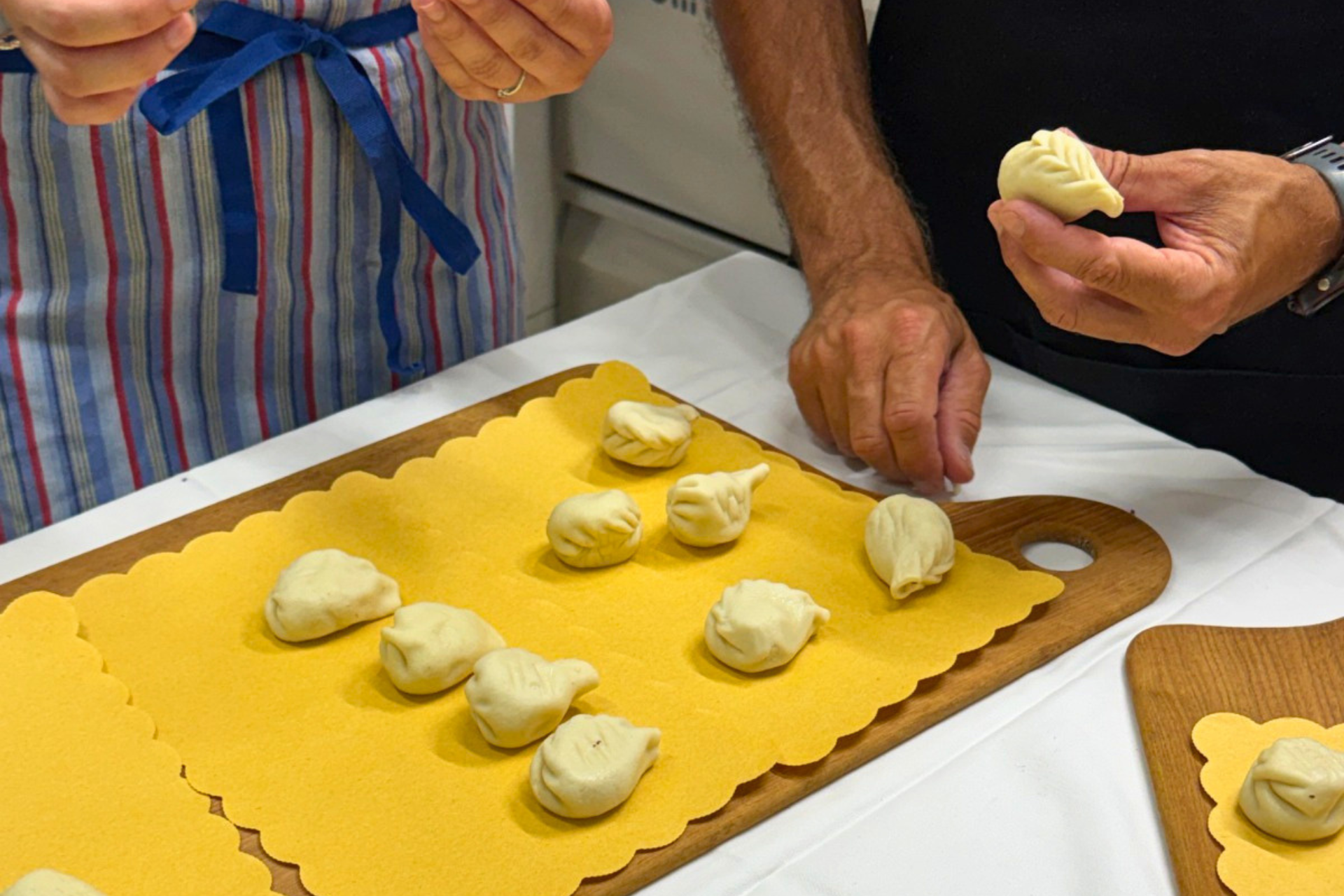 Deux personnes préparent des raviolis et des culurgiones avec des ingrédients frais dans un atelier de pâtes fraîches à Tortolì