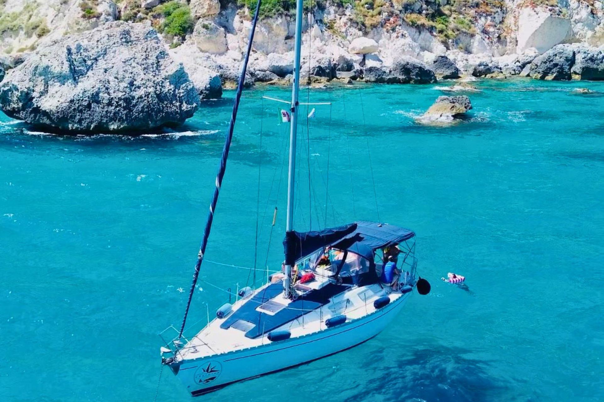 Sailing boat with expert skipper in the Golfo degli Angeli, stops for snorkeling and swimming, aperitif on board with typical Sardinian products