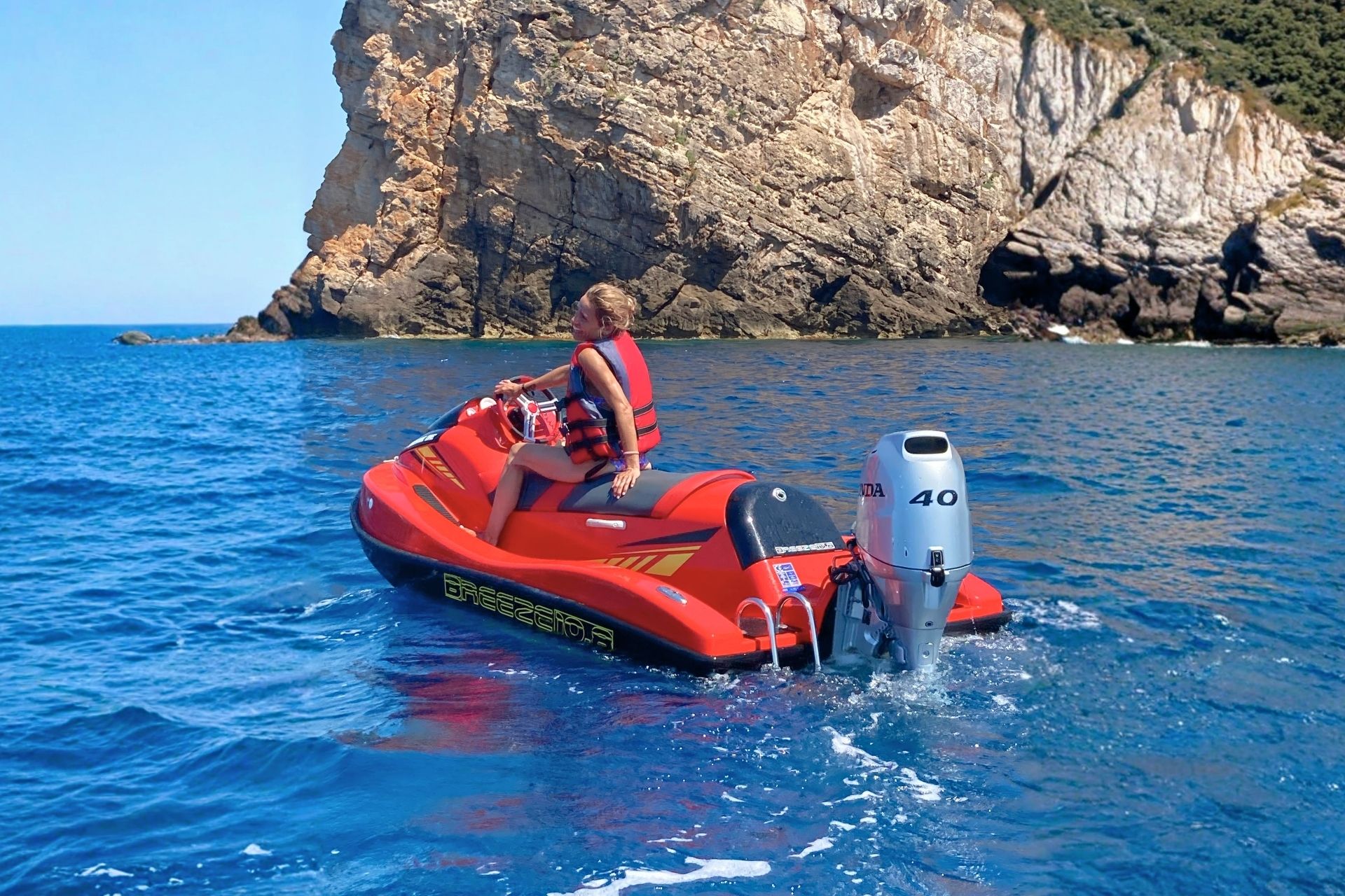 A woman enjoys a jet ski rental experience in Alghero