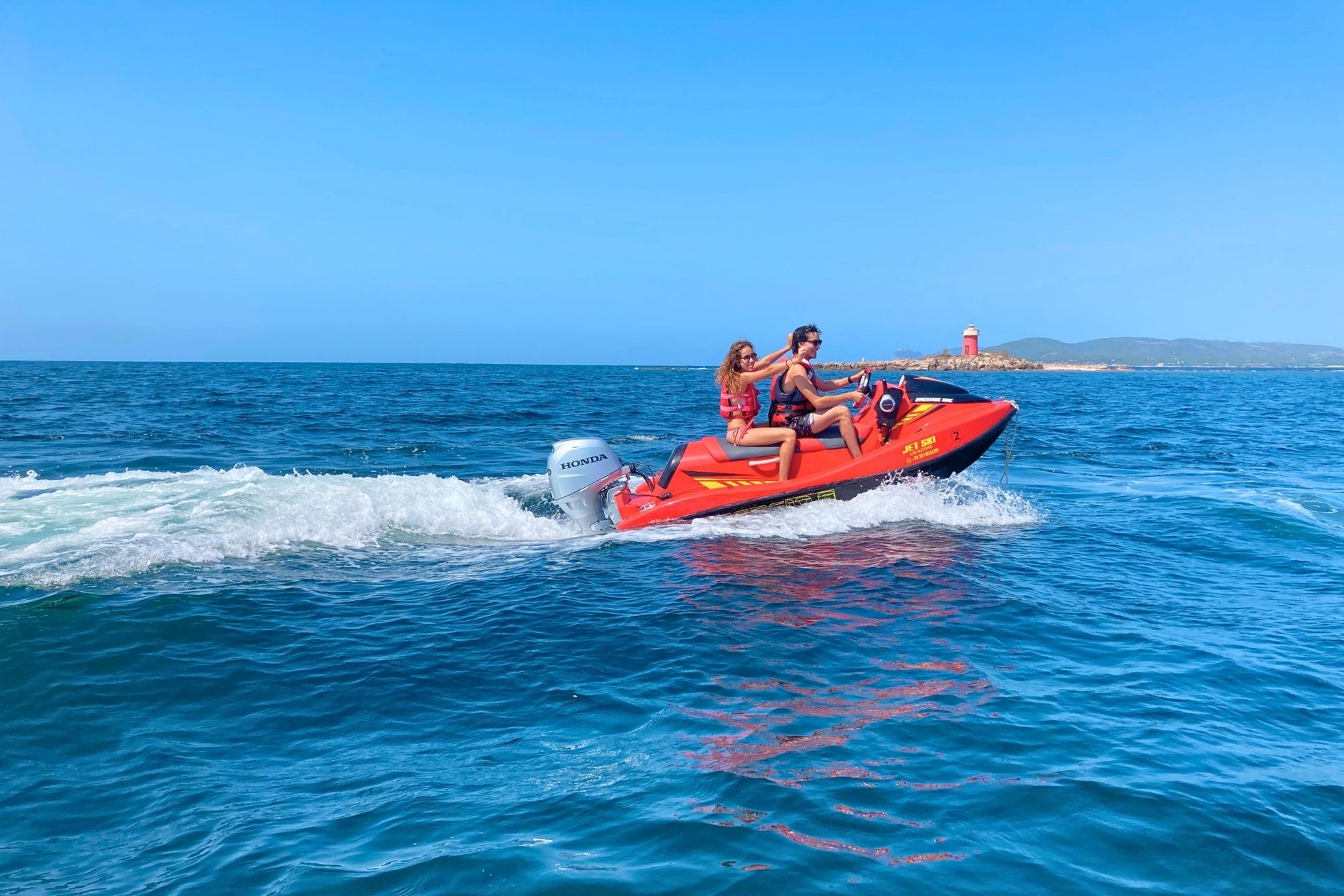Two people enjoy a jet ski rental experience in Alghero