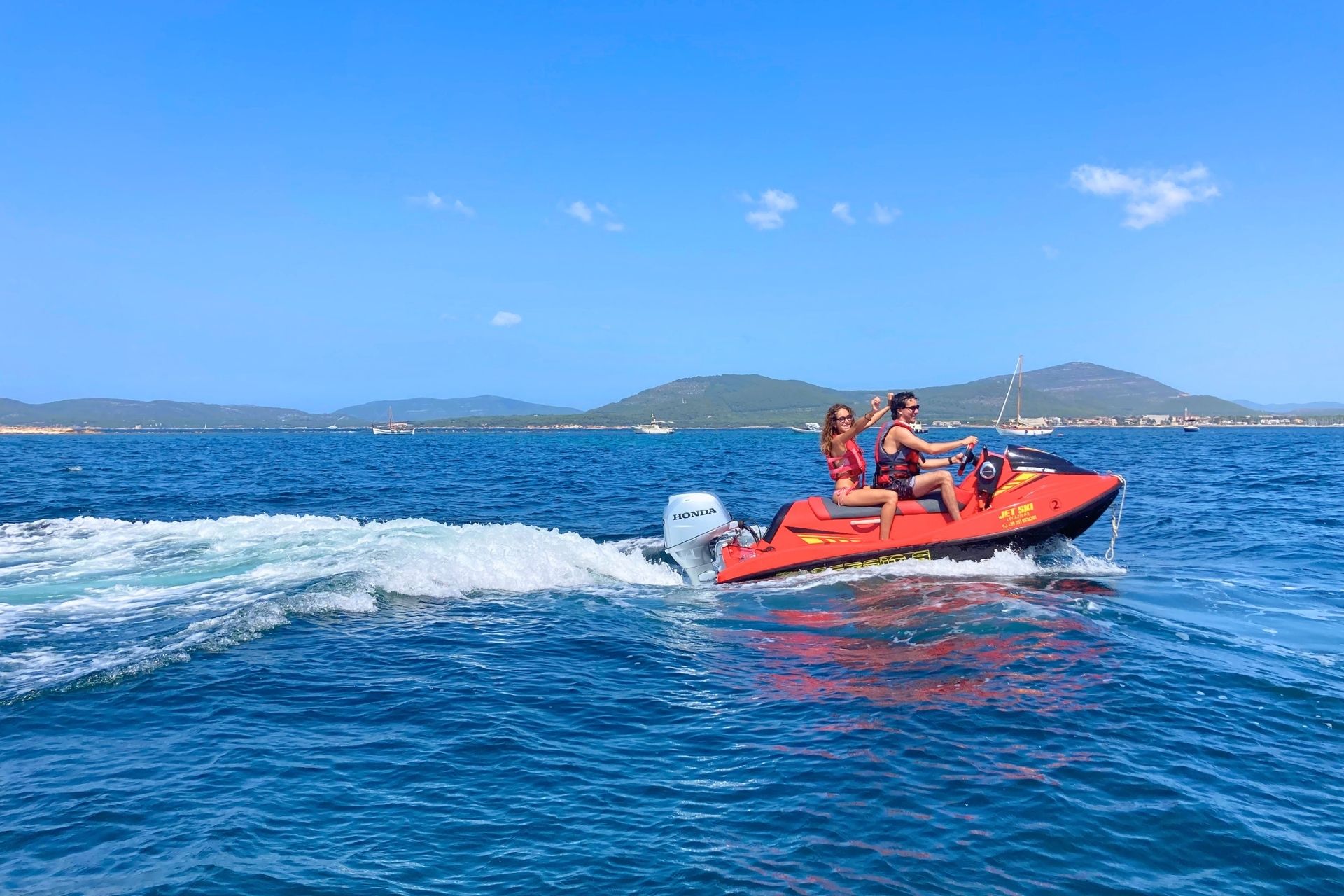 Two people enjoy a jet ski rental experience in Alghero