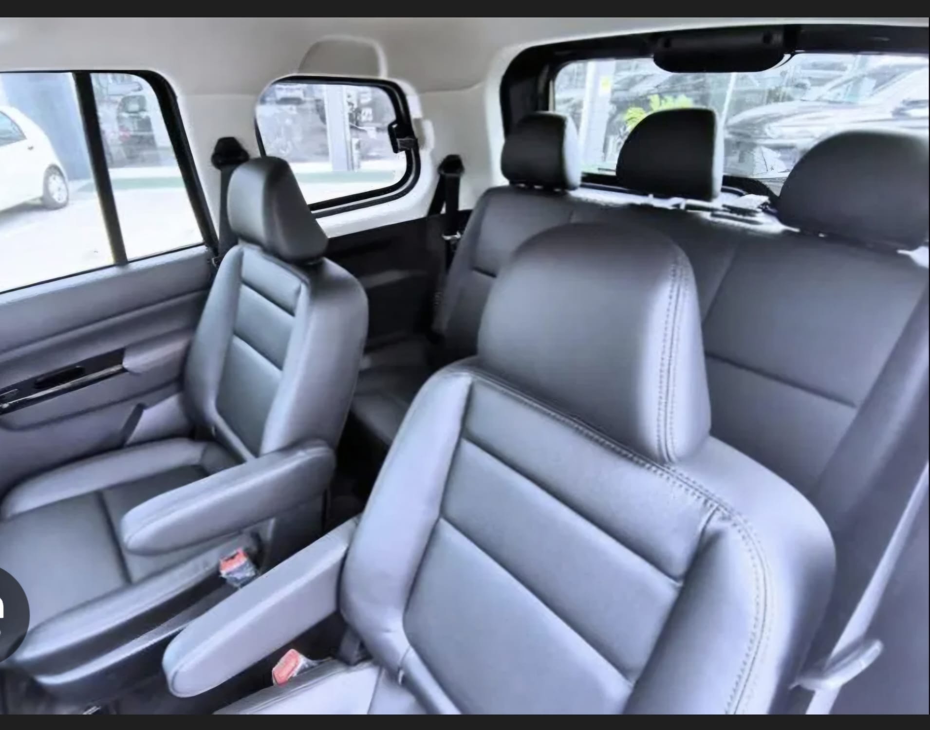 Vehicle interior with gray leather seats and side windows