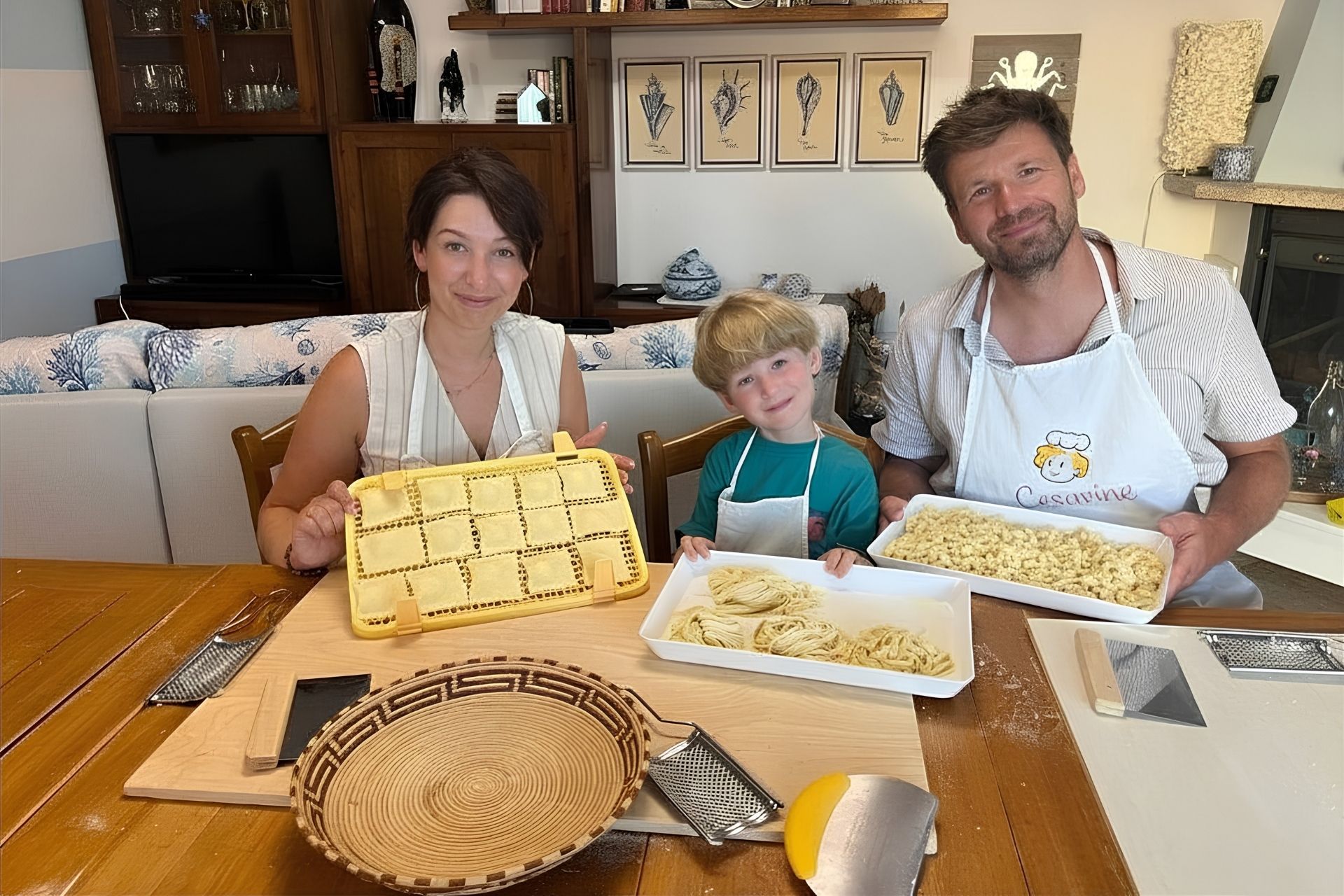 Family intent on preparing fresh Sardinian pasta in a cooking workshop.