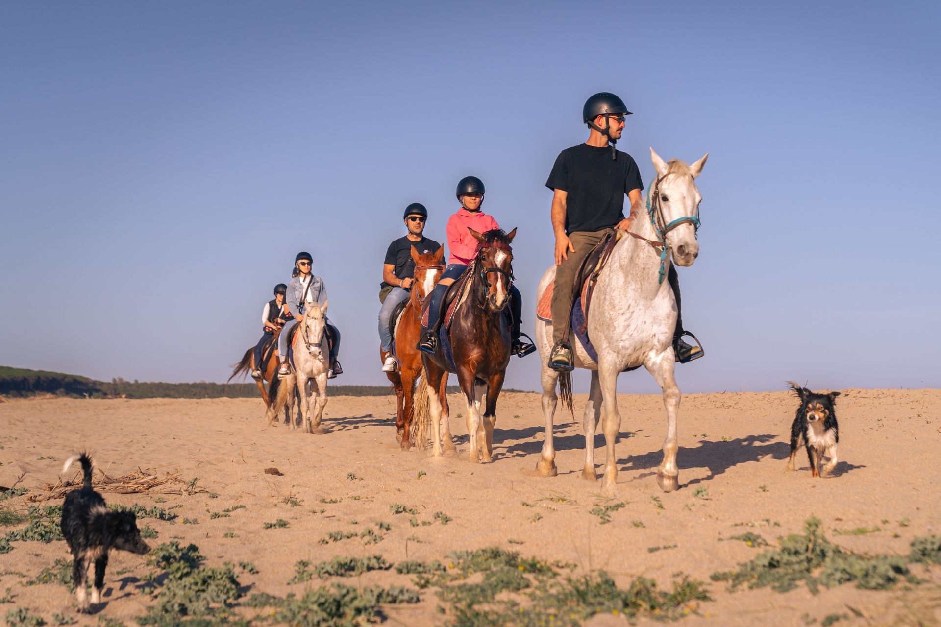 People on horseback during the sunrise excursion to Orosei