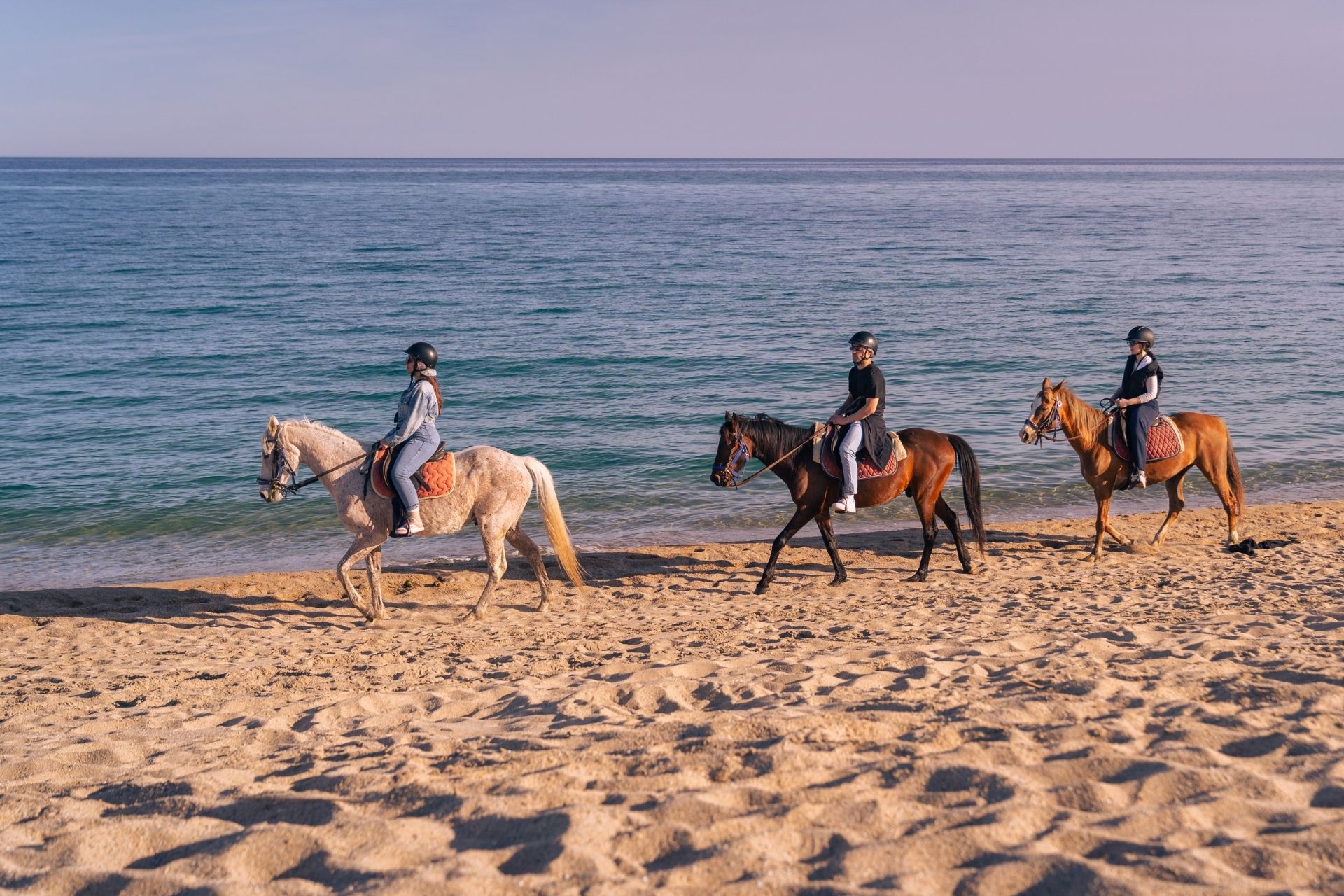 People on horseback during the sunrise excursion to Orosei