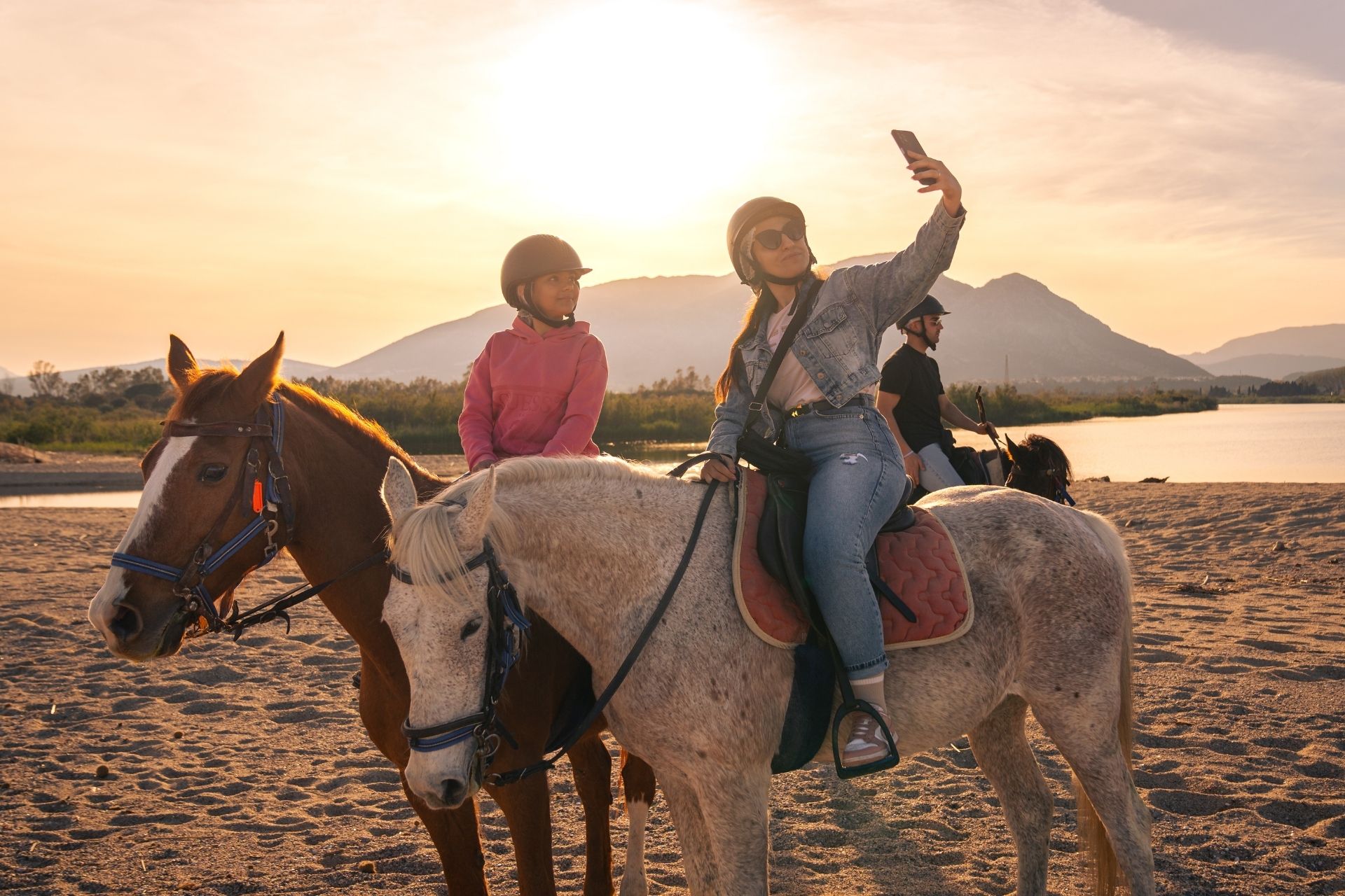 Horseback ride on the beach of Orosei at sunset, at the mouth of the Cedrino river.