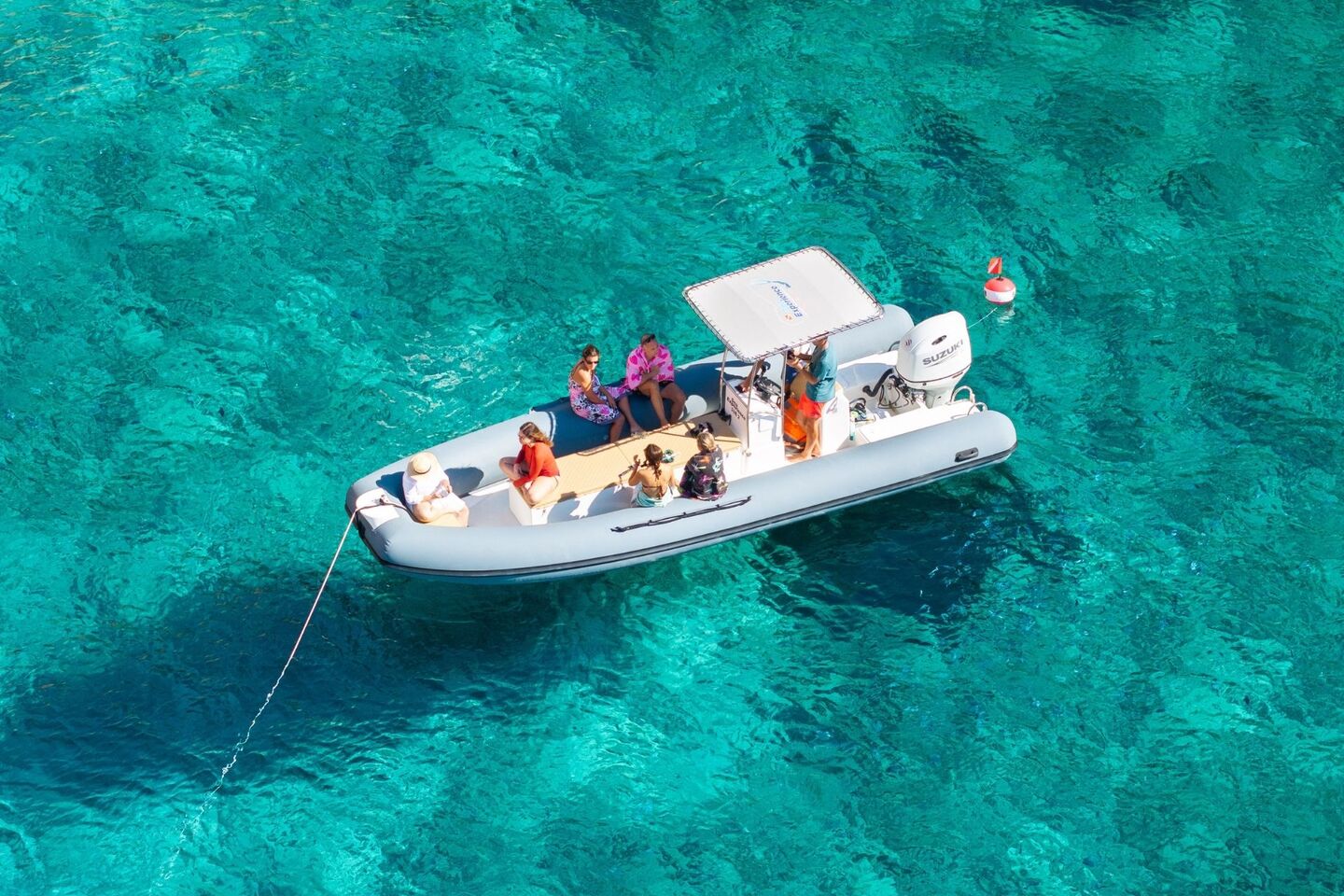 Dinghy stops near the coast of the Porto Conte Park